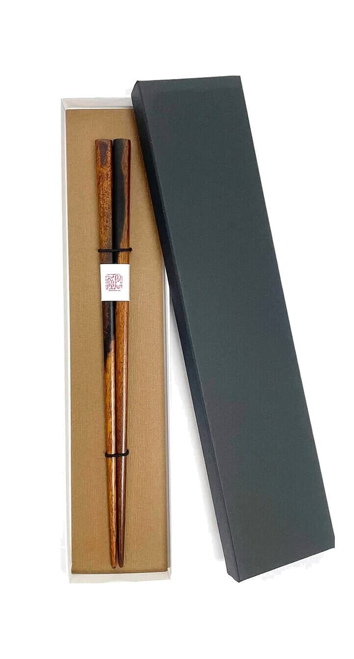 Persimmon wood chopsticks in an open gift box