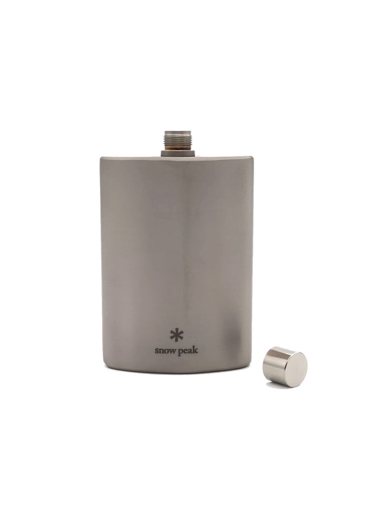 Titanium hip flask with its cap set beside it